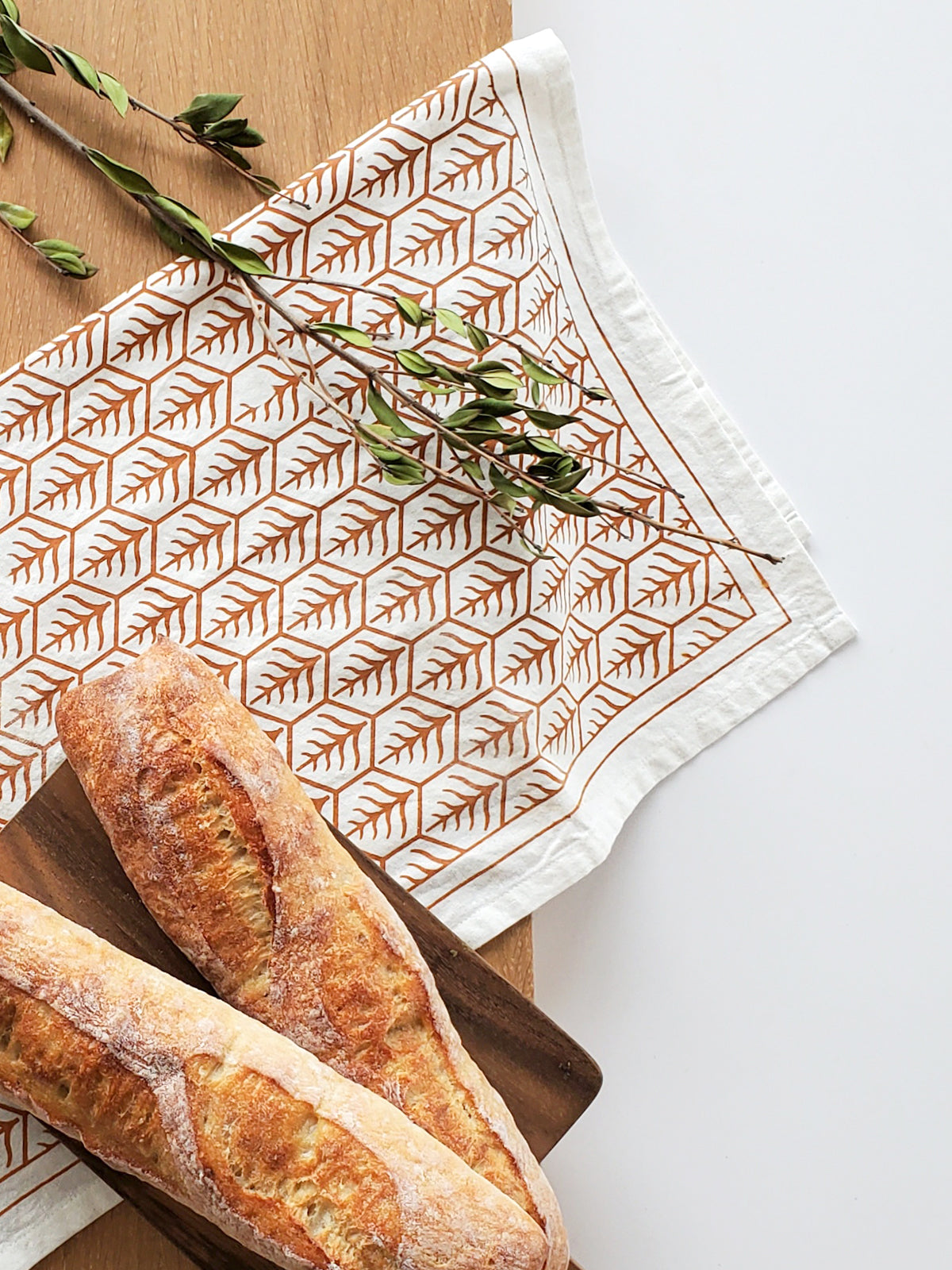 Printed tea towels styled with bread board and bread 