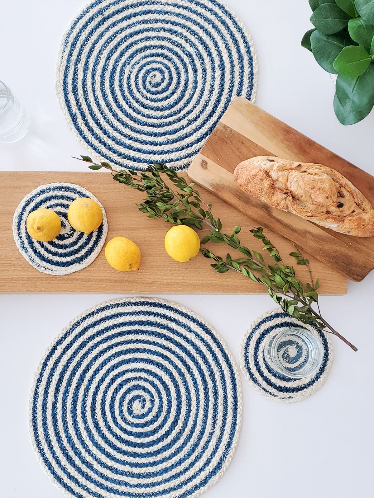 Spiral jute placemat in blue and cream styled with bread board and coasters